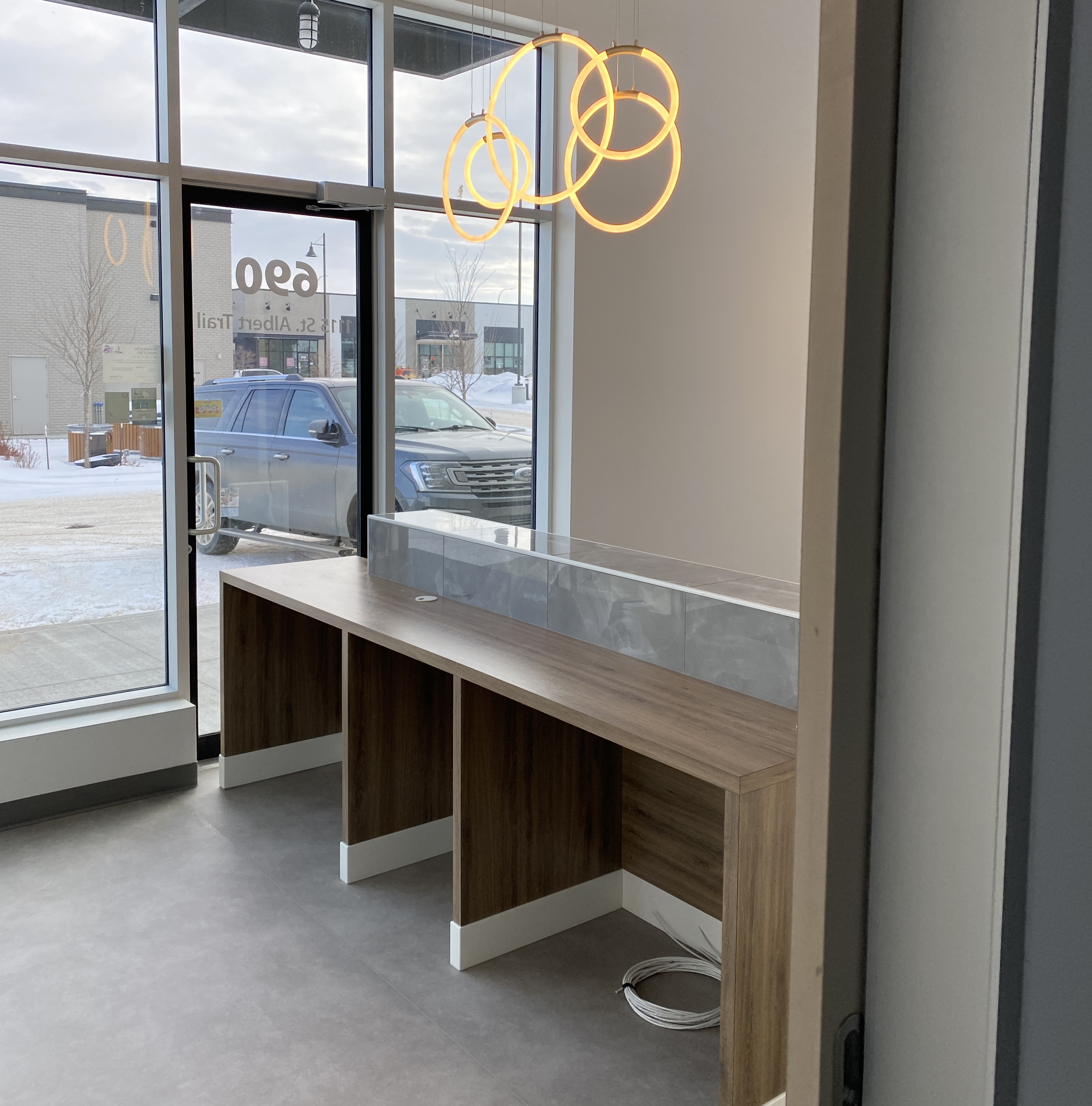 Front reception cabinetry with light wood panels